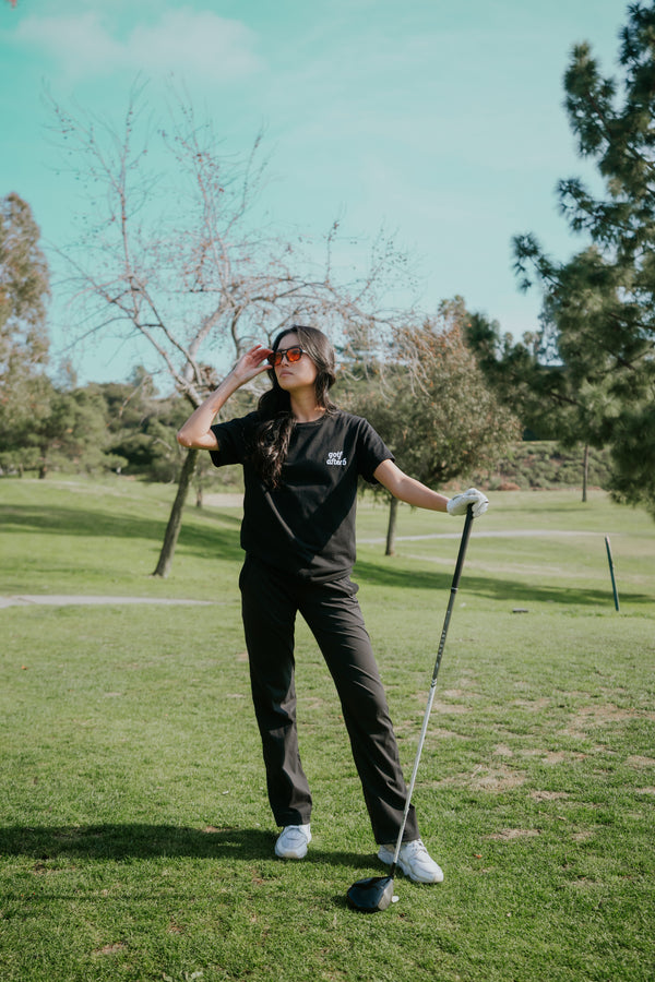Golf After 5 "Golf More, Work Less" women's black t-shirt, front view, female model
