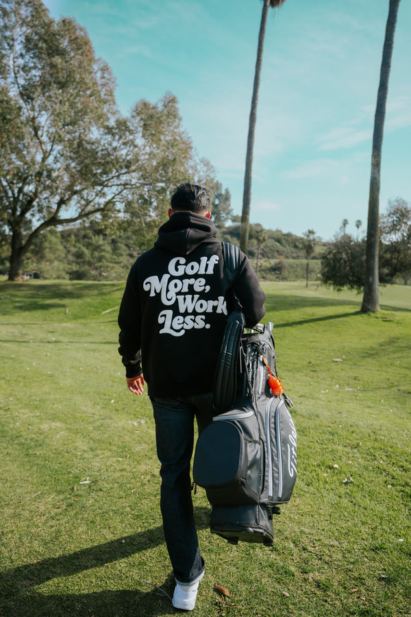 Golf After 5 "Golf More, Work Less" unisex black hoodie, back view, male model, golf course