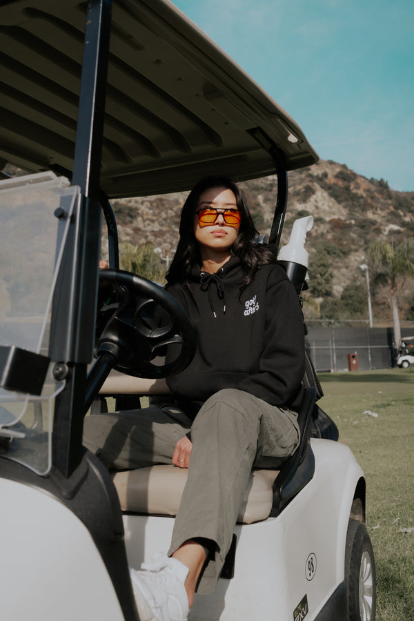 Golf After 5 "Golf More, Work Less" unisex black hoodie, front view, female model