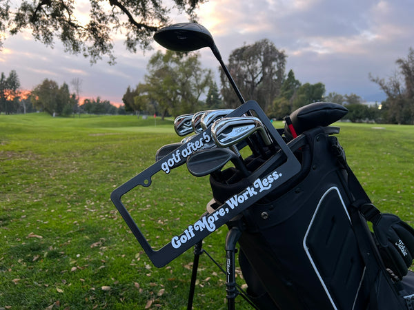Golf After 5 "Golf More, Work Less" license plate with raised white lettering, universal fitting sizing, hanging on golf bag